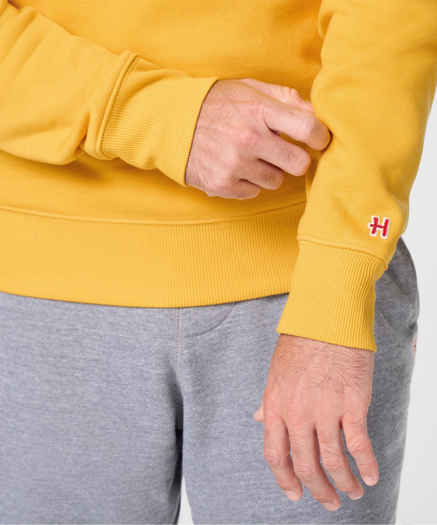 Folded view of the gold Peanuts Charlie Brown sweatshirt showcasing its premium construction