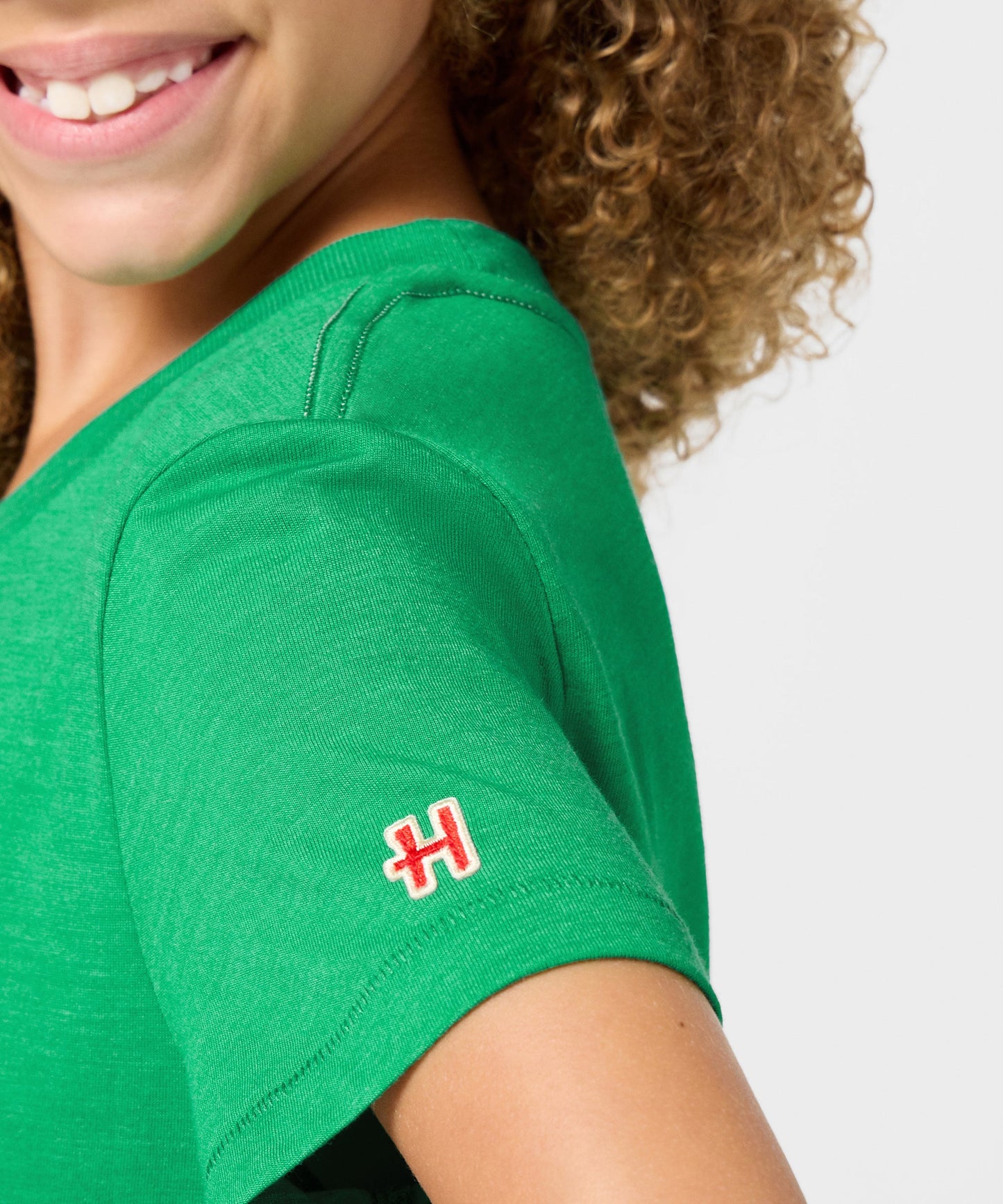 Folded green youth t-shirt showcasing the folded graphic presentation