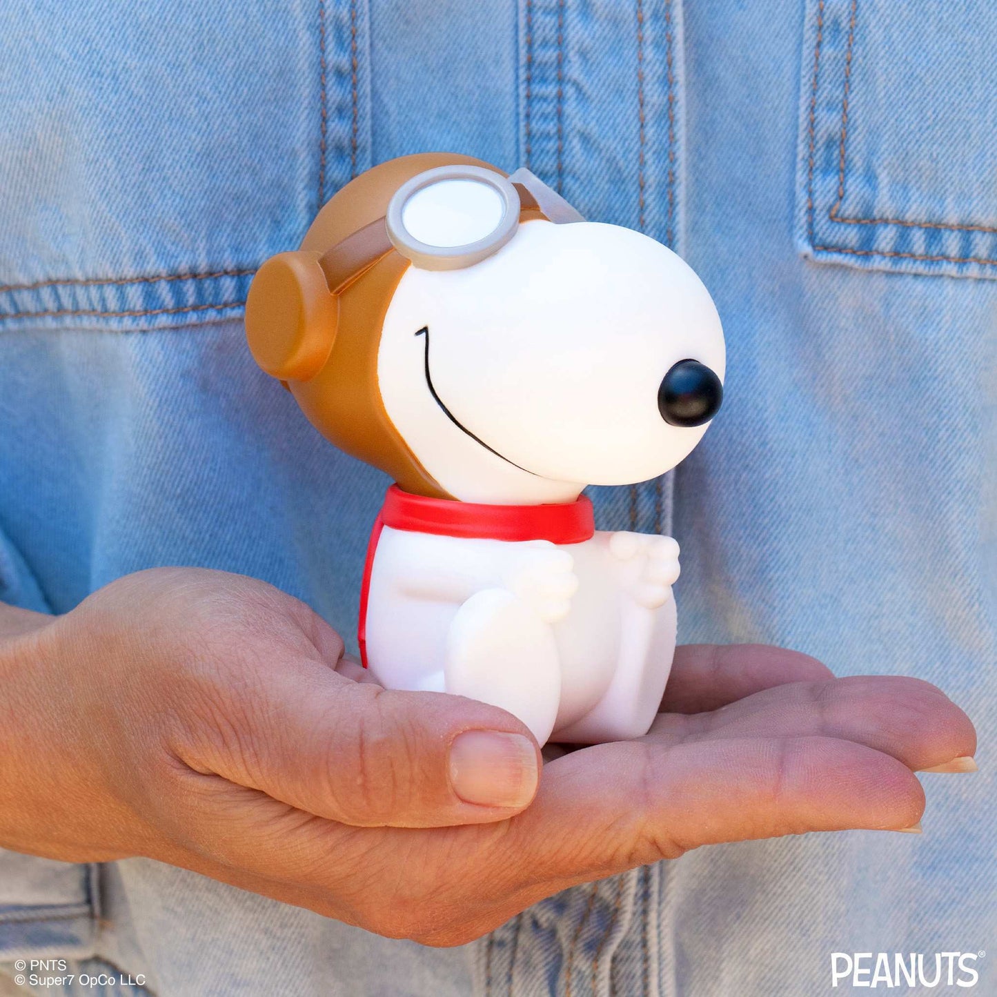 Close-up of Snoopy's face wearing aviator goggles and a white pilot helmet
