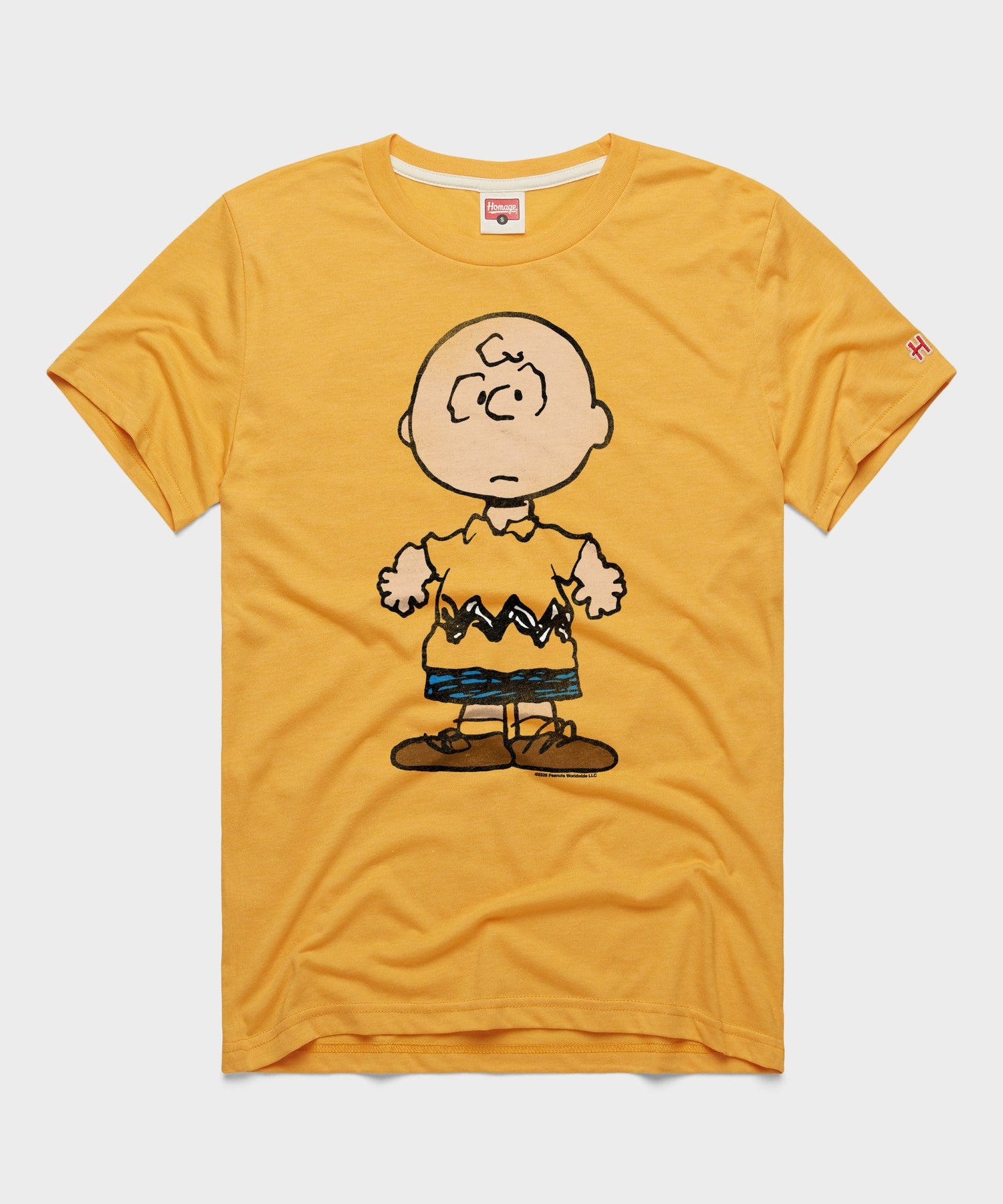 Gold crew-neck t-shirt featuring a vintage graphic of Charlie Brown centered on the front chest