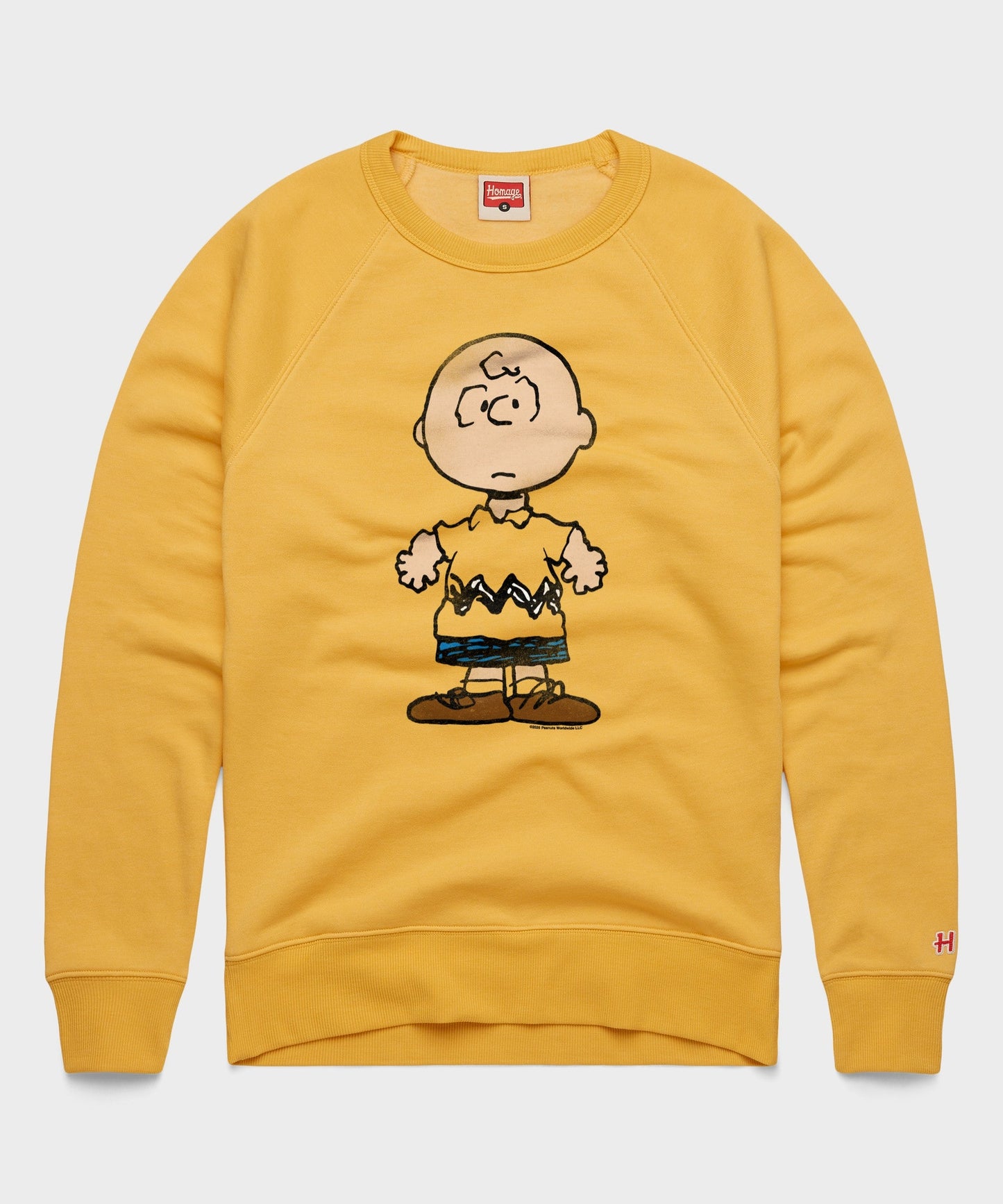 Gold crew-neck sweatshirt featuring a large Charlie Brown graphic centered on the front chest