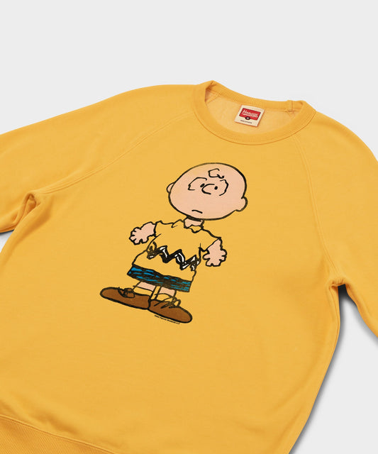 Gold crew-neck sweatshirt featuring a large Charlie Brown graphic centered on the front chest-1