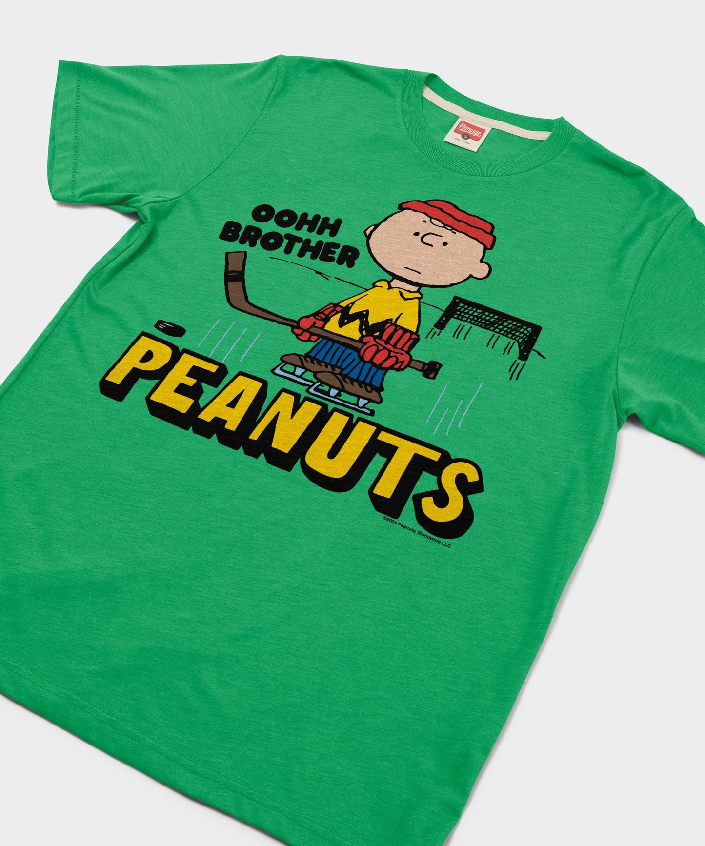 Close-up of the Charlie Brown hockey graphic printed in retro colors on the green t-shirt