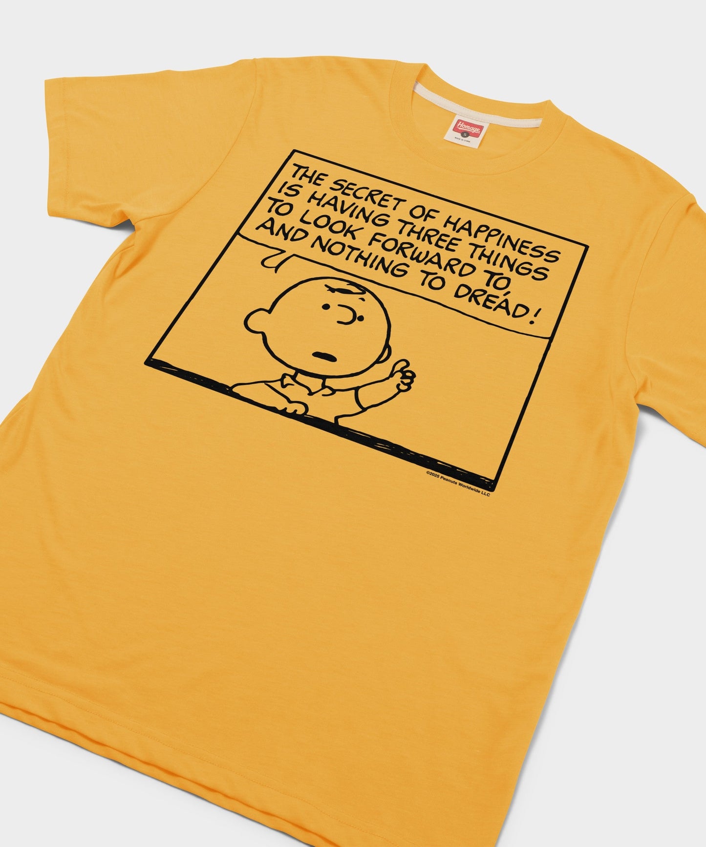 Close-up of the Charlie Brown graphic and the ultra-soft gold fabric texture