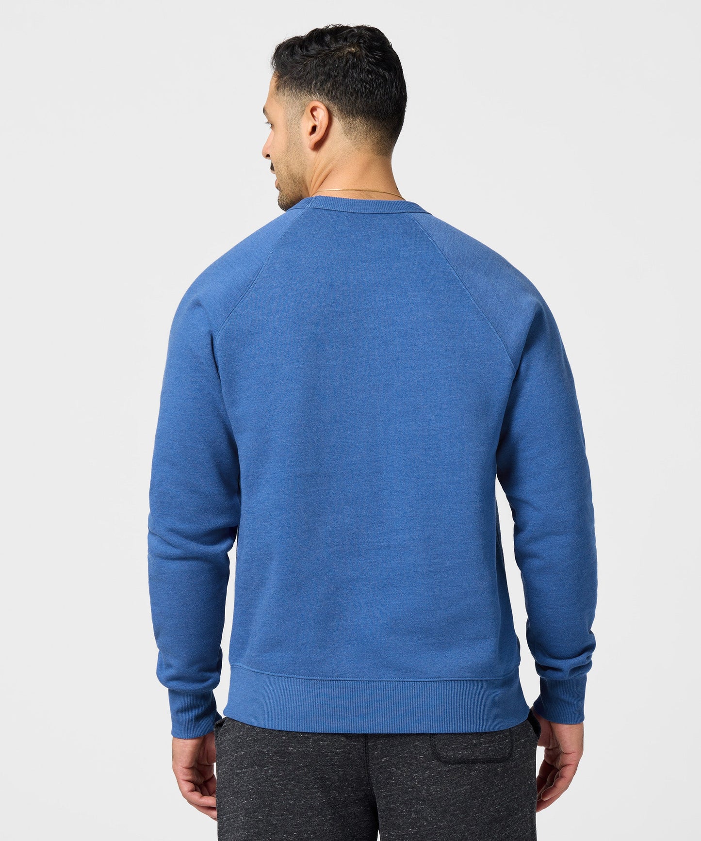 Close-up detail of the fabric texture and royal blue color of the HOMAGE sweatshirt