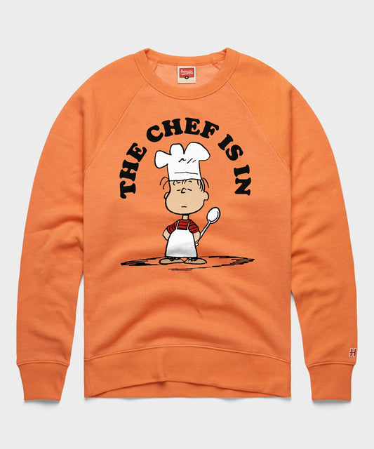 Orange crewneck sweatshirt featuring Linus van Pelt with a chef hat and apron on the front-0