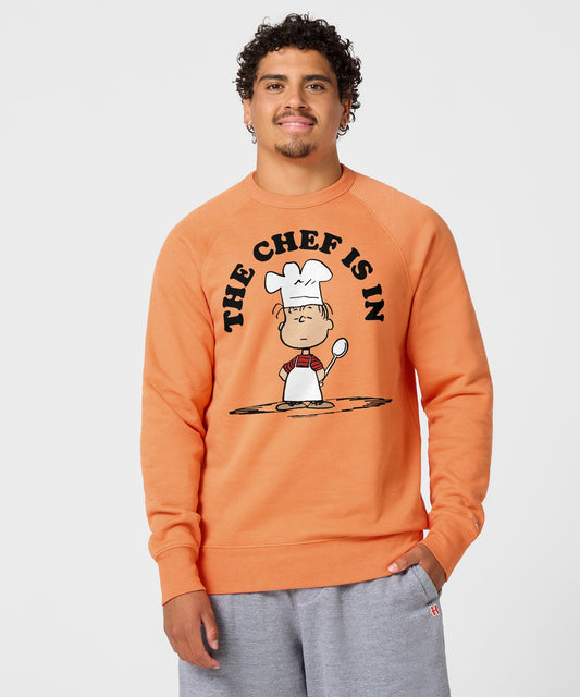 Orange crewneck sweatshirt featuring Linus van Pelt with a chef hat and apron on the front-2