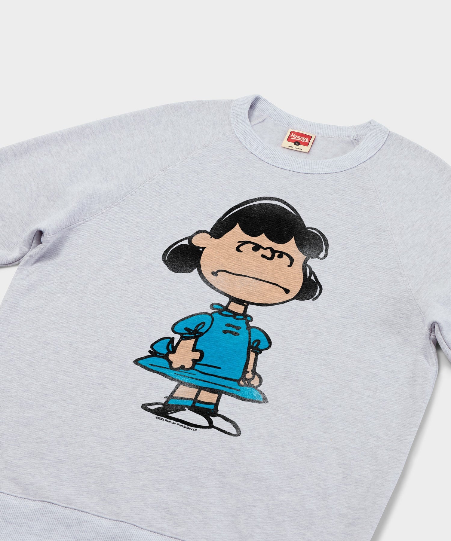 Close-up view of the Lucy character graphic printed on the front of the sweatshirt