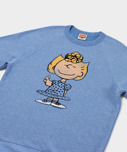 Light blue crewneck sweatshirt featuring Sally Brown with her arms crossed on the front center-1
