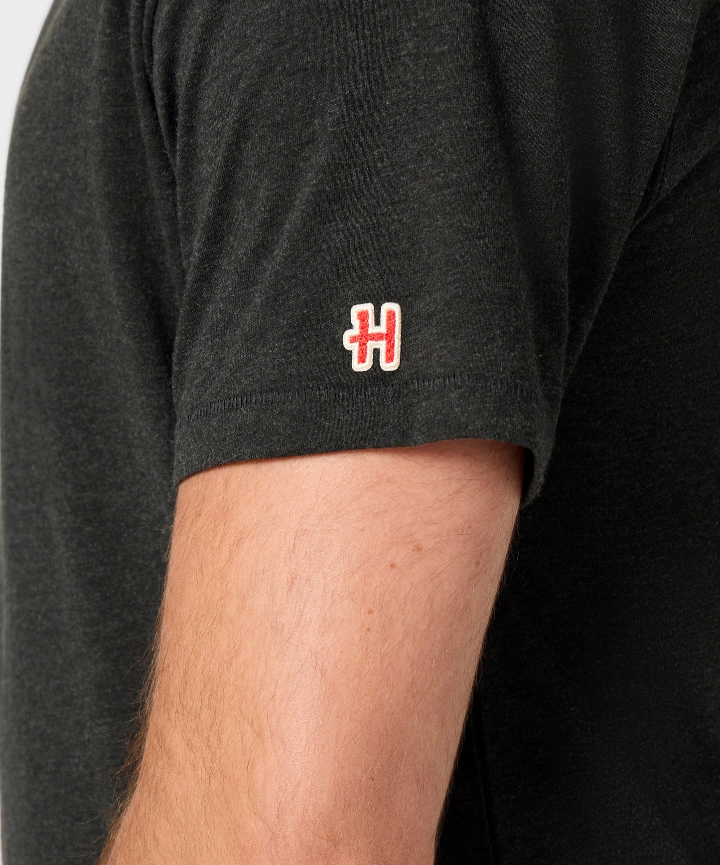 Folded stack of the charcoal Peanuts t-shirt highlighting the soft knit material