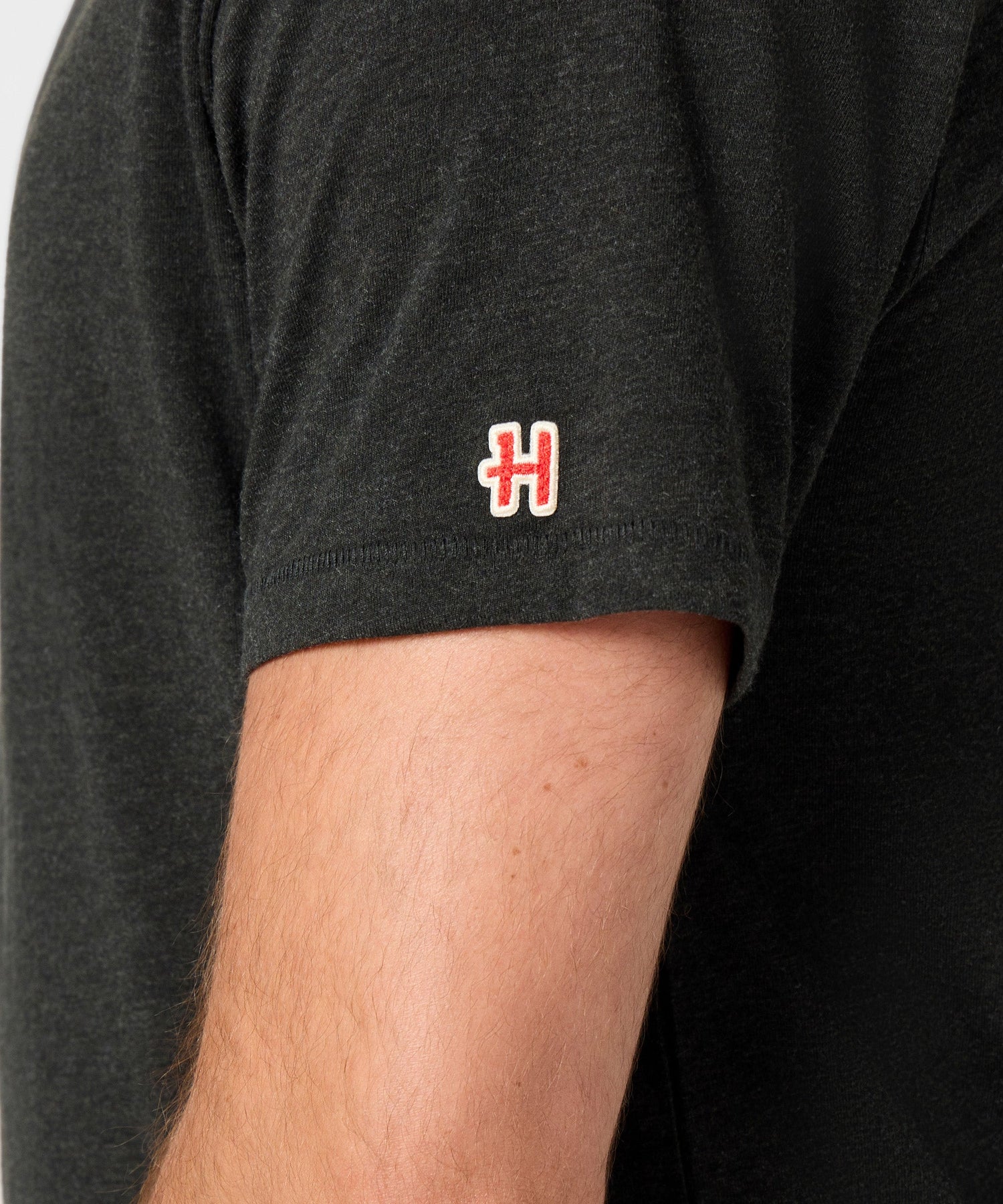 Folded stack of the charcoal Peanuts t-shirt highlighting the soft knit material