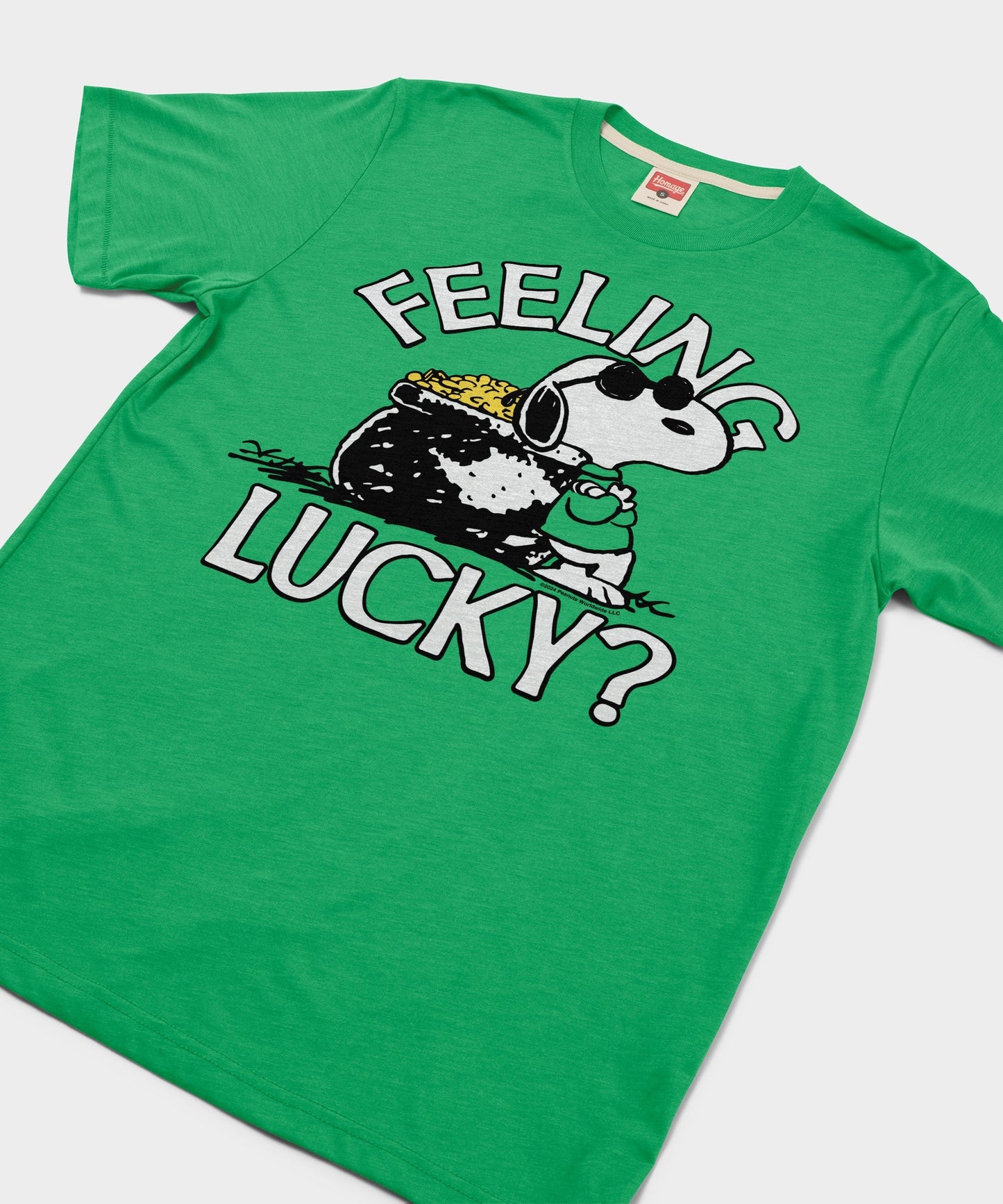 Close-up of the Snoopy graphic printed on the green cotton t-shirt