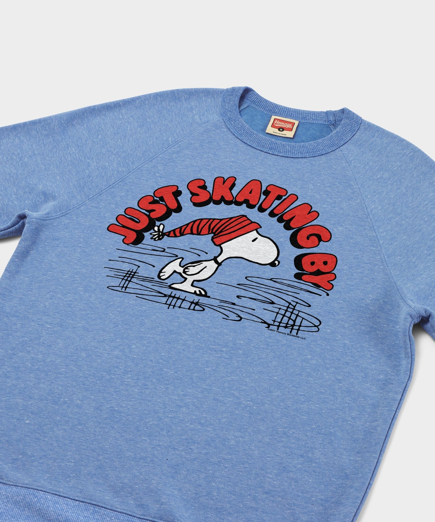 Close-up of the Snoopy ice skating graphic printed on the sweatshirt