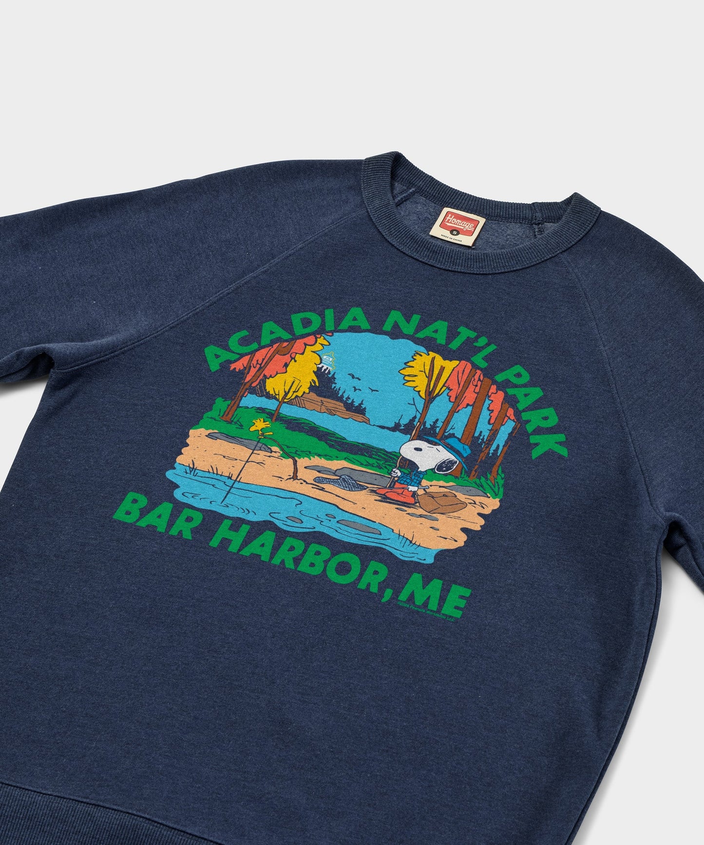 Close-up of the graphic print showing Snoopy against a scenic coastal national park backdrop