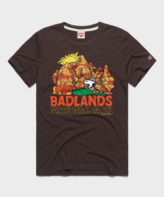 Brown t-shirt featuring Snoopy exploring Badlands National Park on the front chest-0