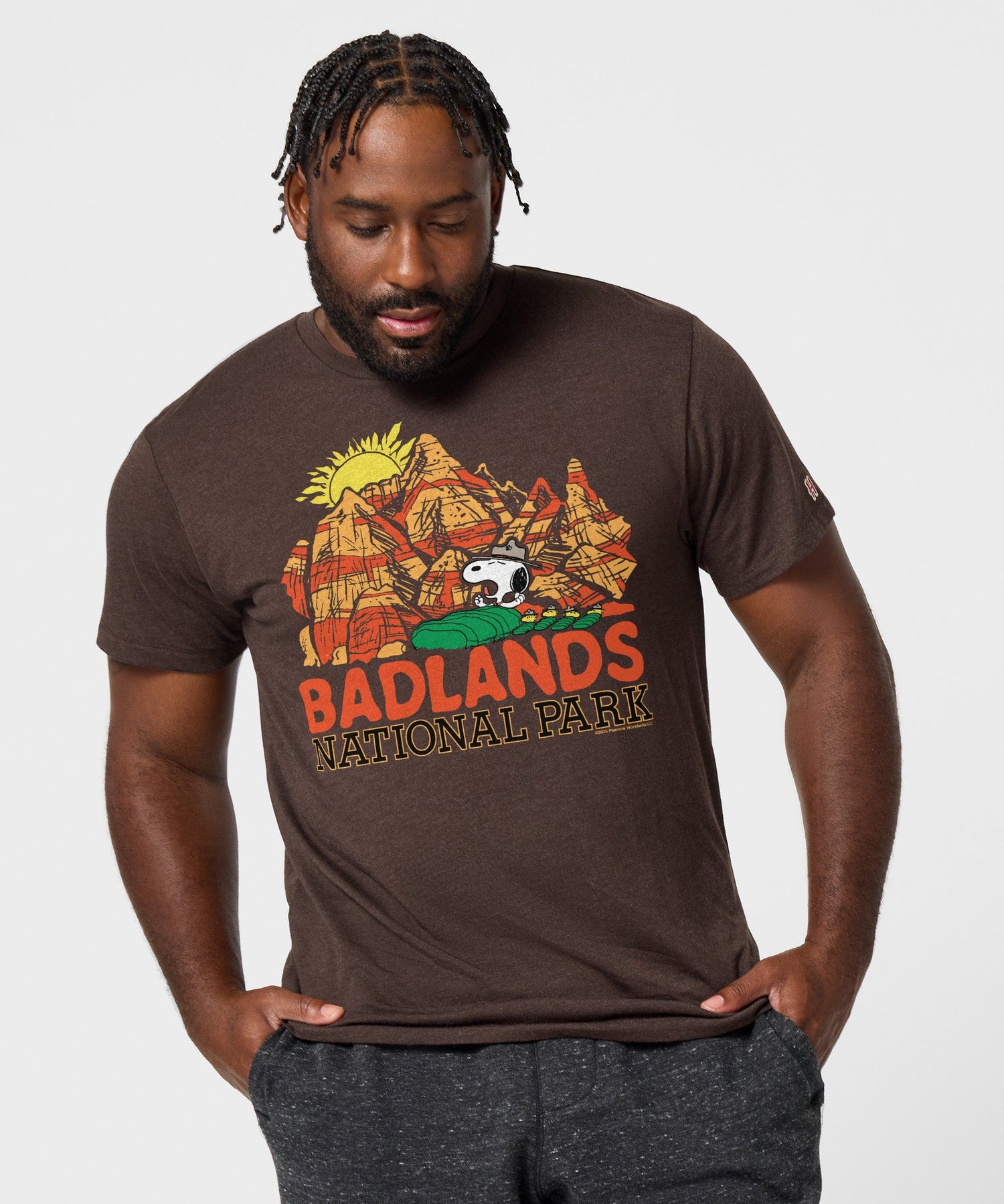 View of the collar and shoulder stitching on the brown Peanuts graphic tee