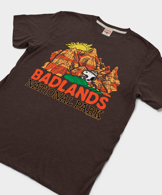 Brown t-shirt featuring Snoopy exploring Badlands National Park on the front chest-1