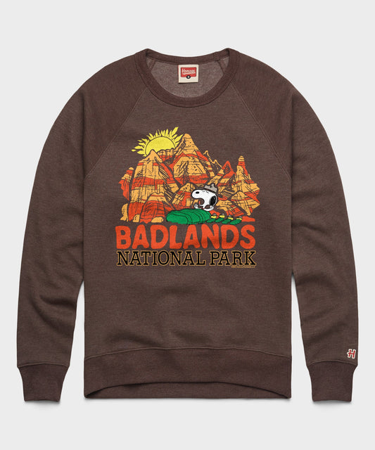 Brown crewneck sweatshirt featuring Snoopy resting in Badlands National Park on the front chest-0