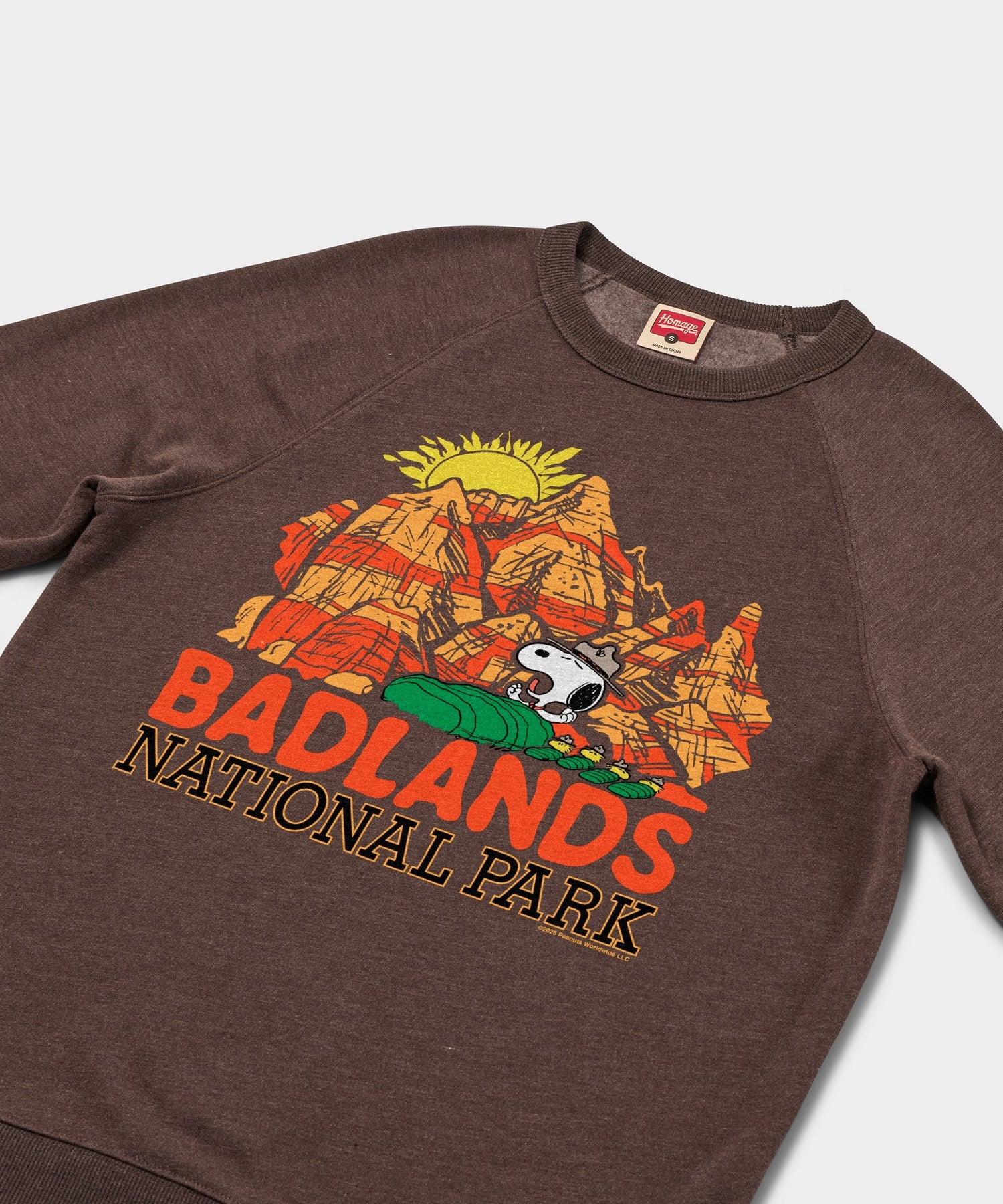 Close-up of the Snoopy and Badlands National Park graphic illustration on the sweatshirt front
