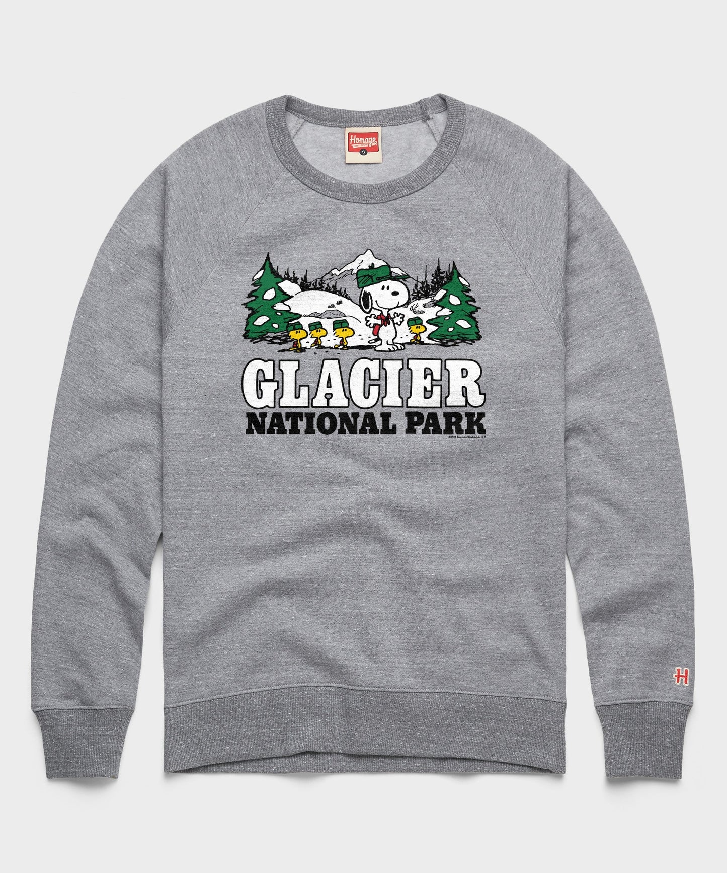 Gray crewneck sweatshirt featuring Snoopy ready for an alpine adventure in Glacier National Park printed on the front chest