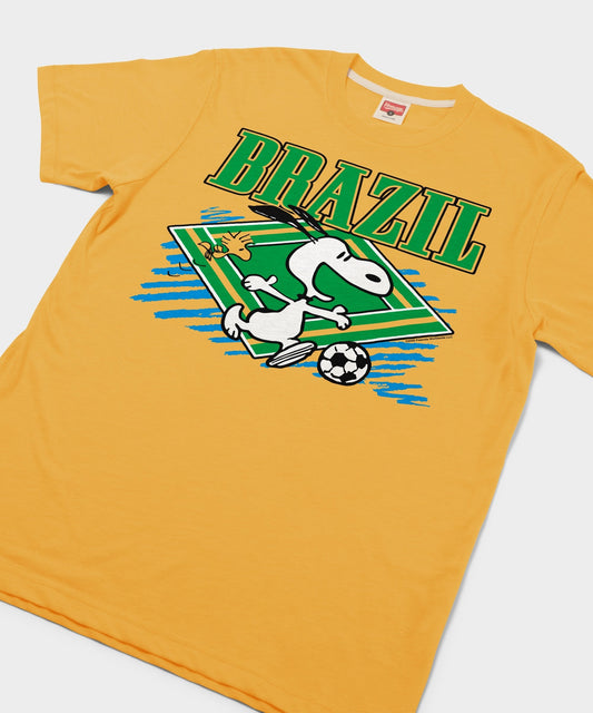 Gold tri-blend t-shirt featuring Snoopy playing soccer in Brazil team colors centered on the front-1
