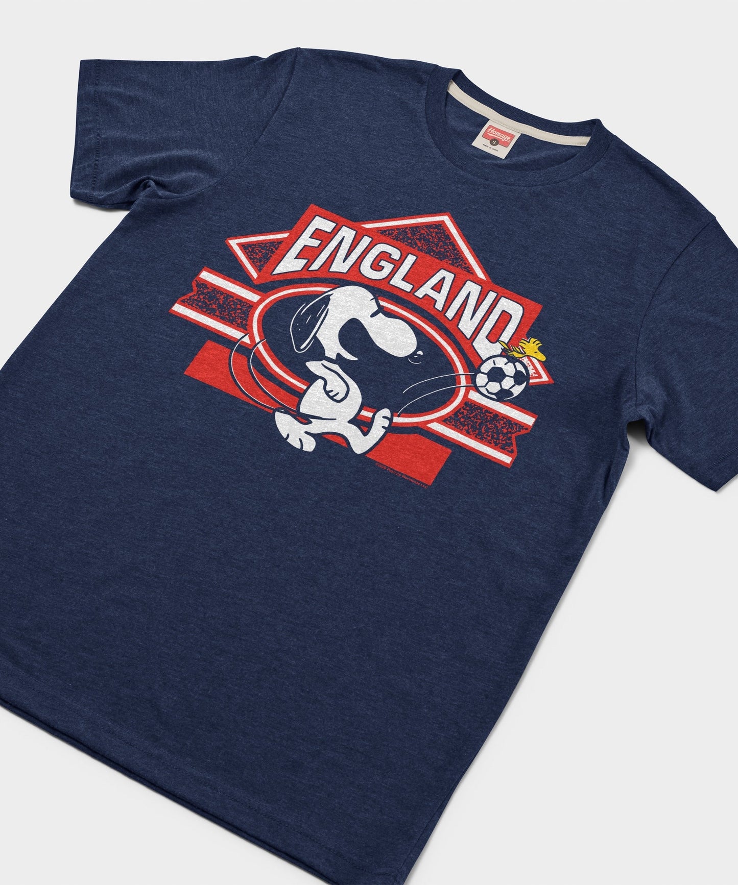 Close-up of the Snoopy England soccer graphic on the chest of the navy t-shirt
