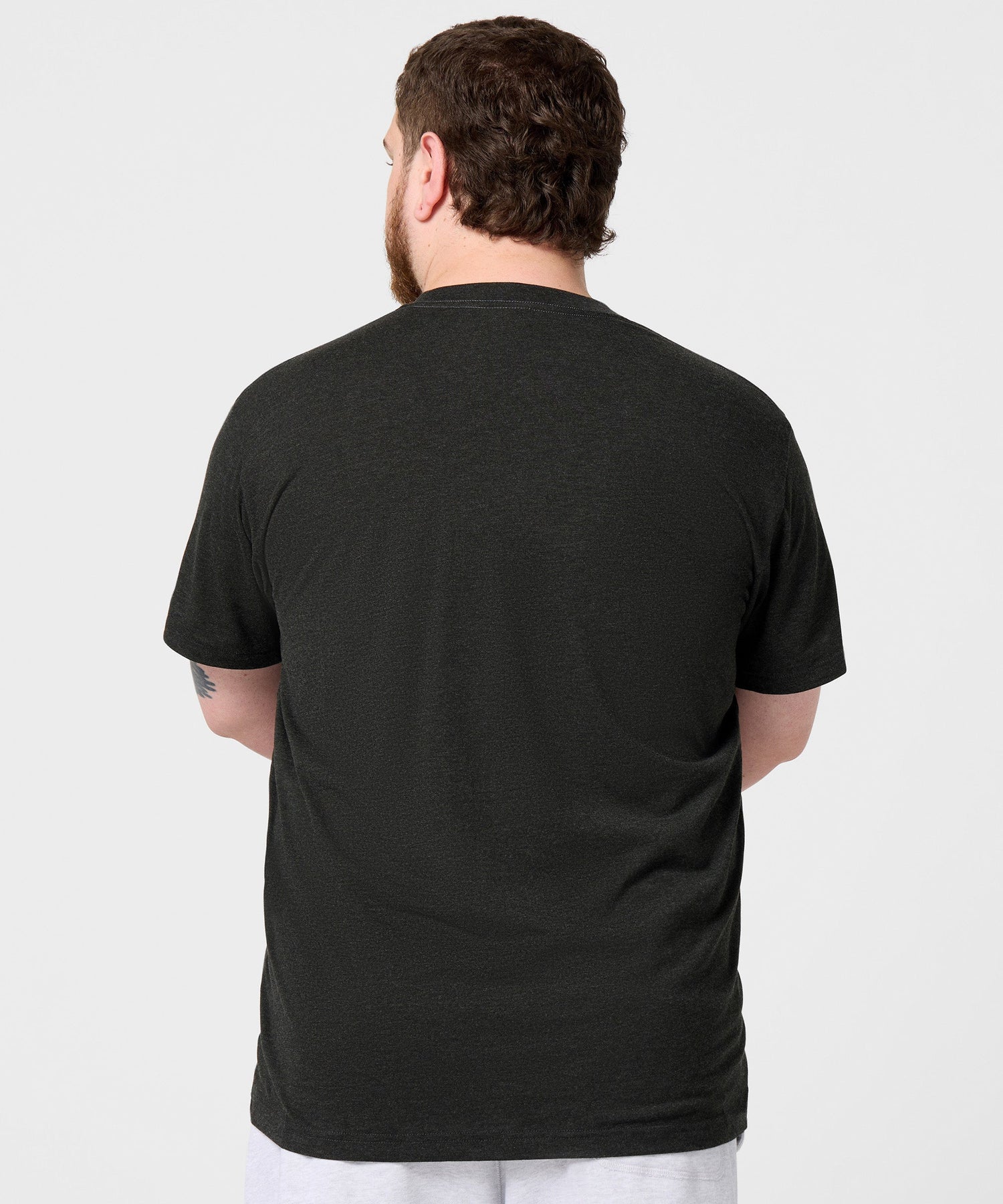 Detailed view of the HOMAGE collar tag and inner neckline fabric
