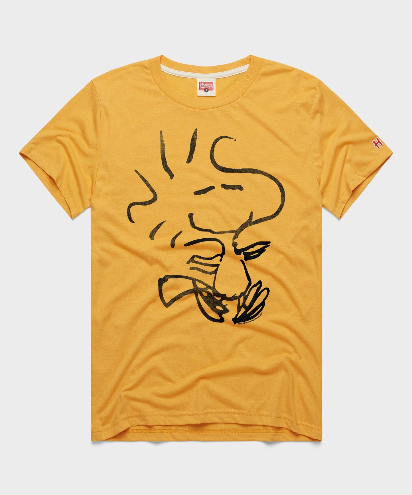 Gold HOMAGE t-shirt featuring a graphic of Woodstock from Peanuts centered on the front