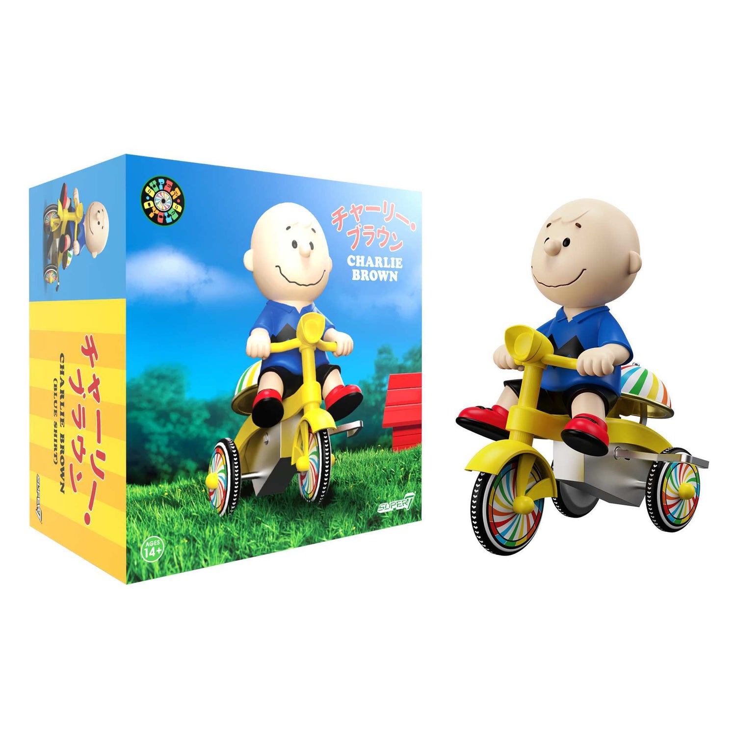 Charlie Brown in a soft vinyl finish riding a blue and yellow wind-up tricycle.