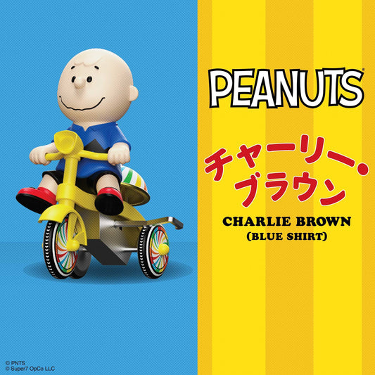 Charlie Brown in a soft vinyl finish riding a blue and yellow wind-up tricycle.-1