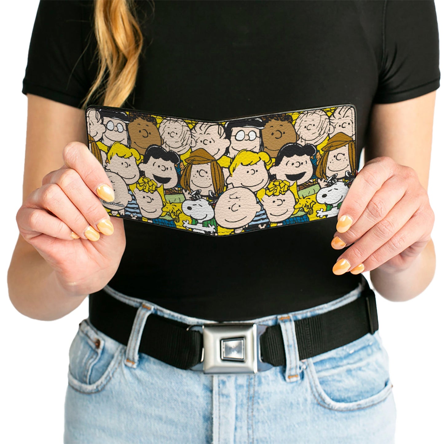 Lifestyle view of the Peanuts wallet resting on a neutral surface