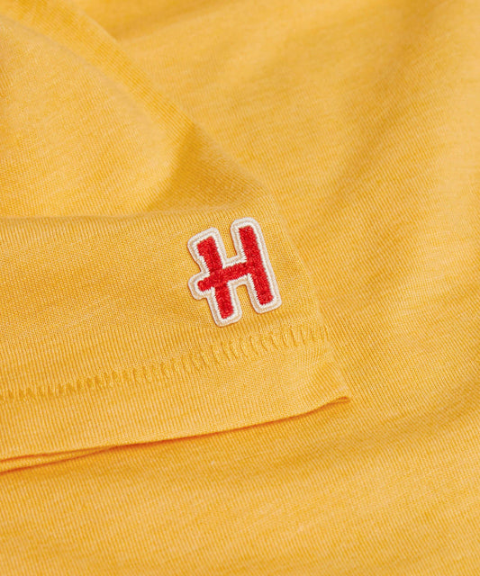 Gold women's t-shirt featuring a vintage graphic of Charlie Brown centered on the front-4