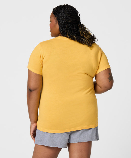Gold women's t-shirt featuring a vintage graphic of Charlie Brown centered on the front-3