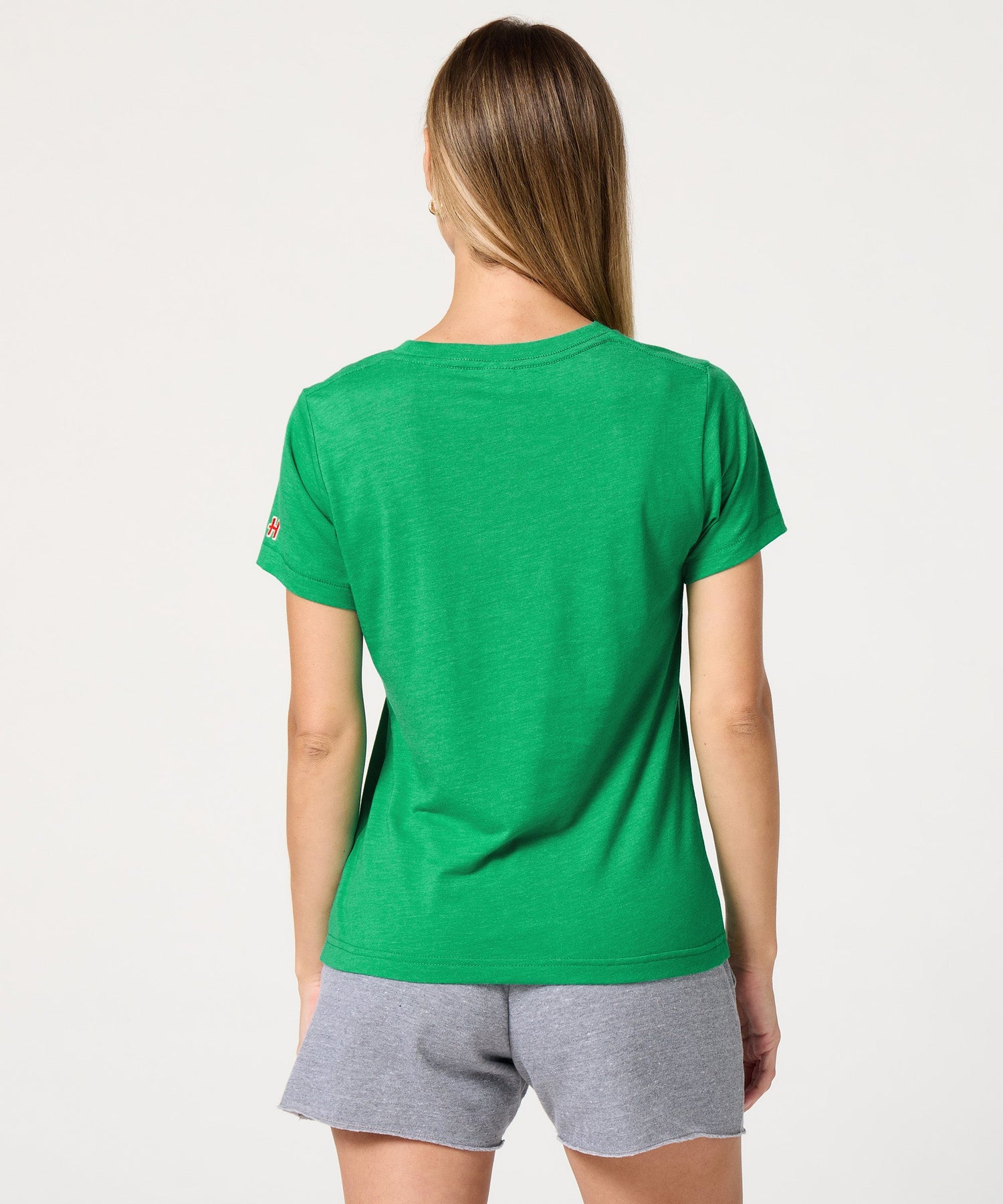 Back view of the solid green women's t-shirt with a clean, unprinted finish