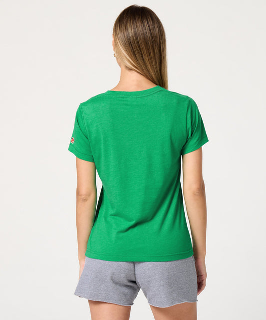Green women's crewneck t-shirt with a vintage Charlie Brown skating graphic centered on the chest-3
