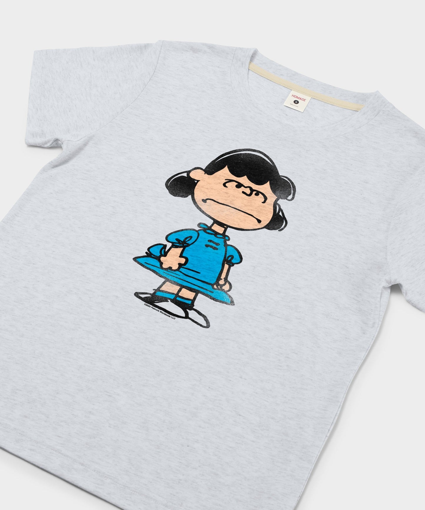 Close-up of the Lucy van Pelt graphic print on the front of the ash t-shirt
