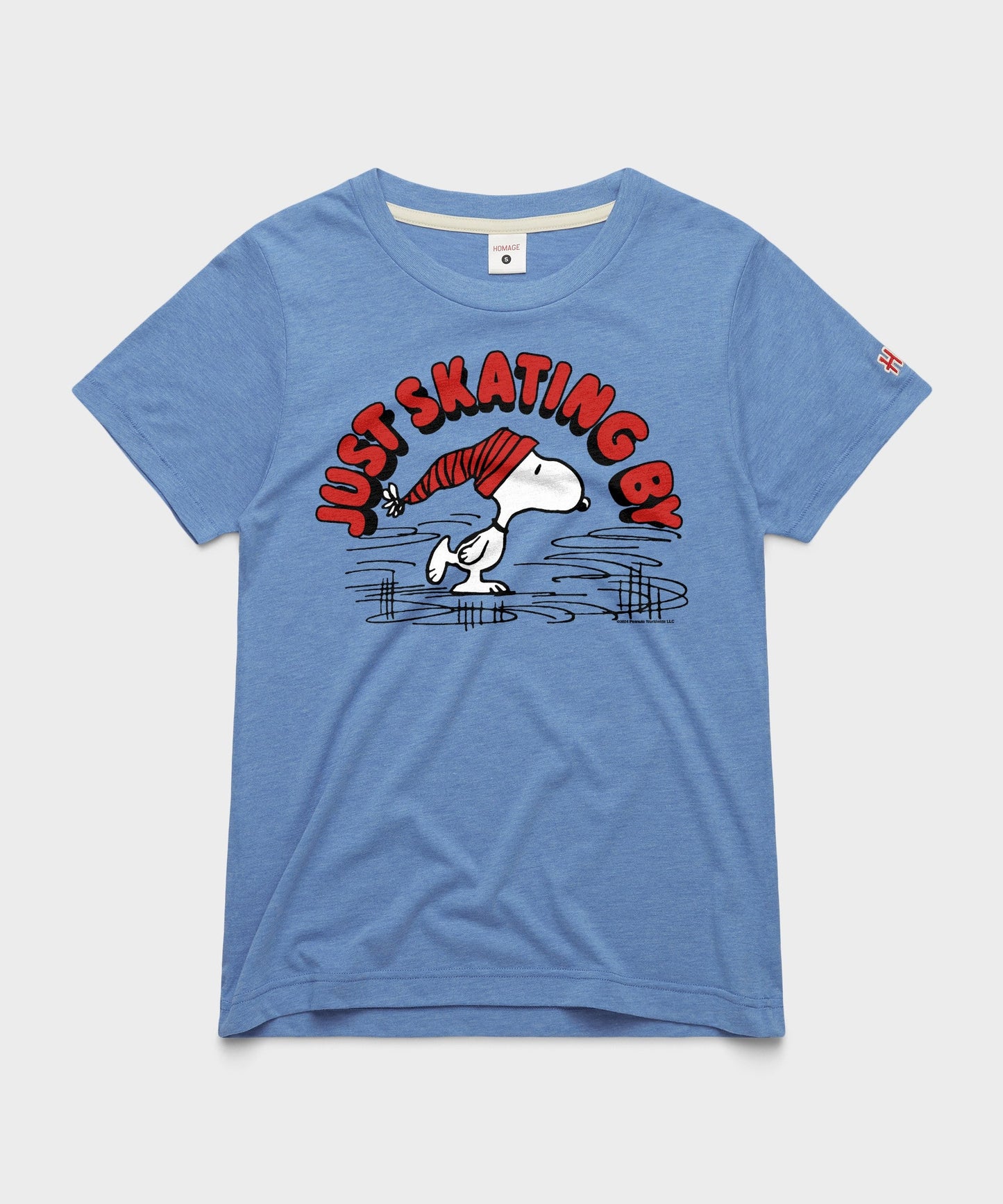 Light blue women's t-shirt featuring Snoopy ice skating on the front chest
