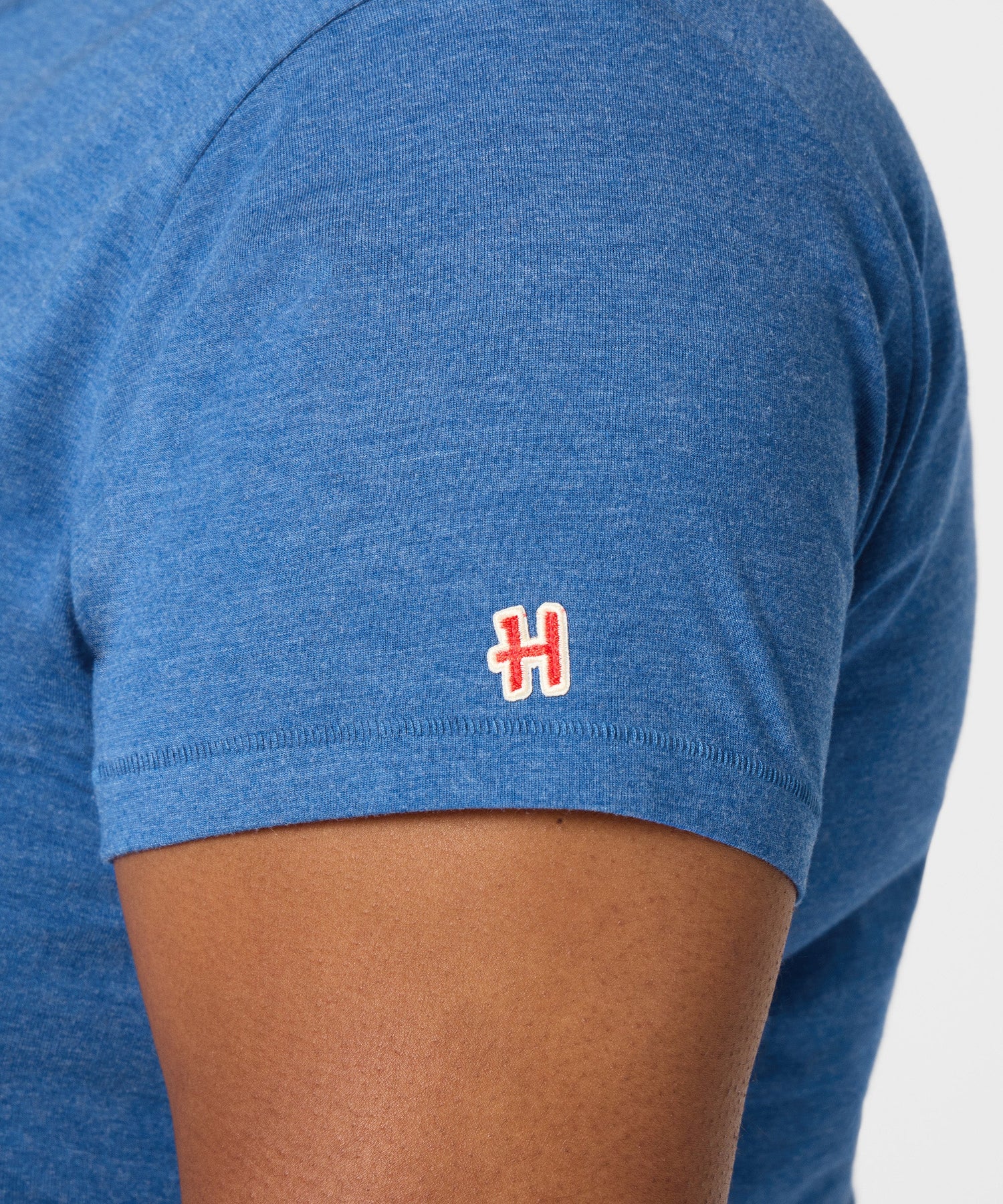 Detail shot of the HOMAGE collar tag and soft fabric texture inside the t-shirt