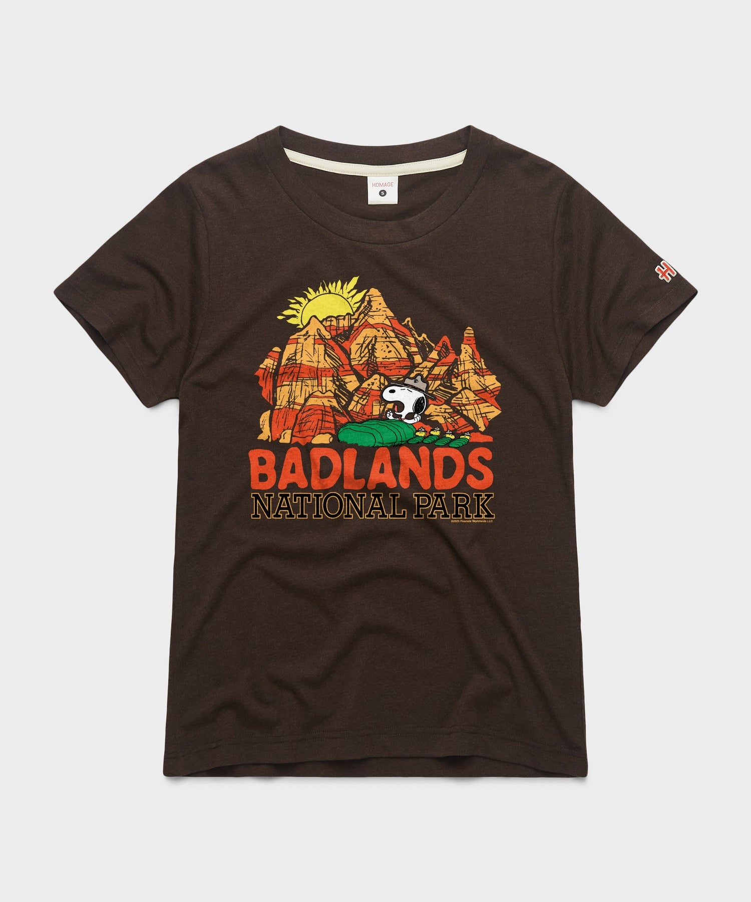 Brown women's t-shirt with a graphic of Snoopy resting near Badlands National Park on the chest