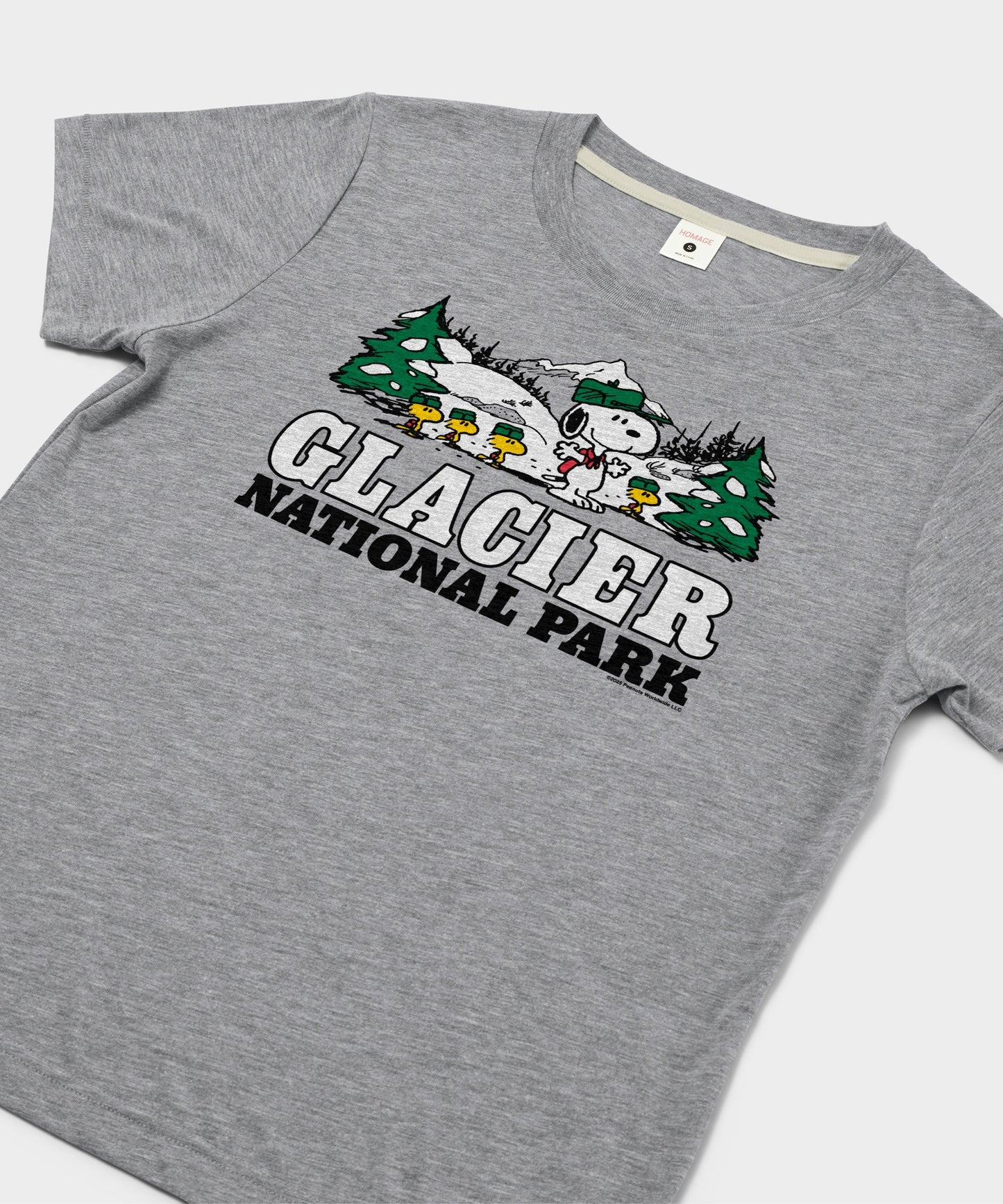 Close-up of the Snoopy and Glacier National Park graphic illustration on the grey t-shirt front