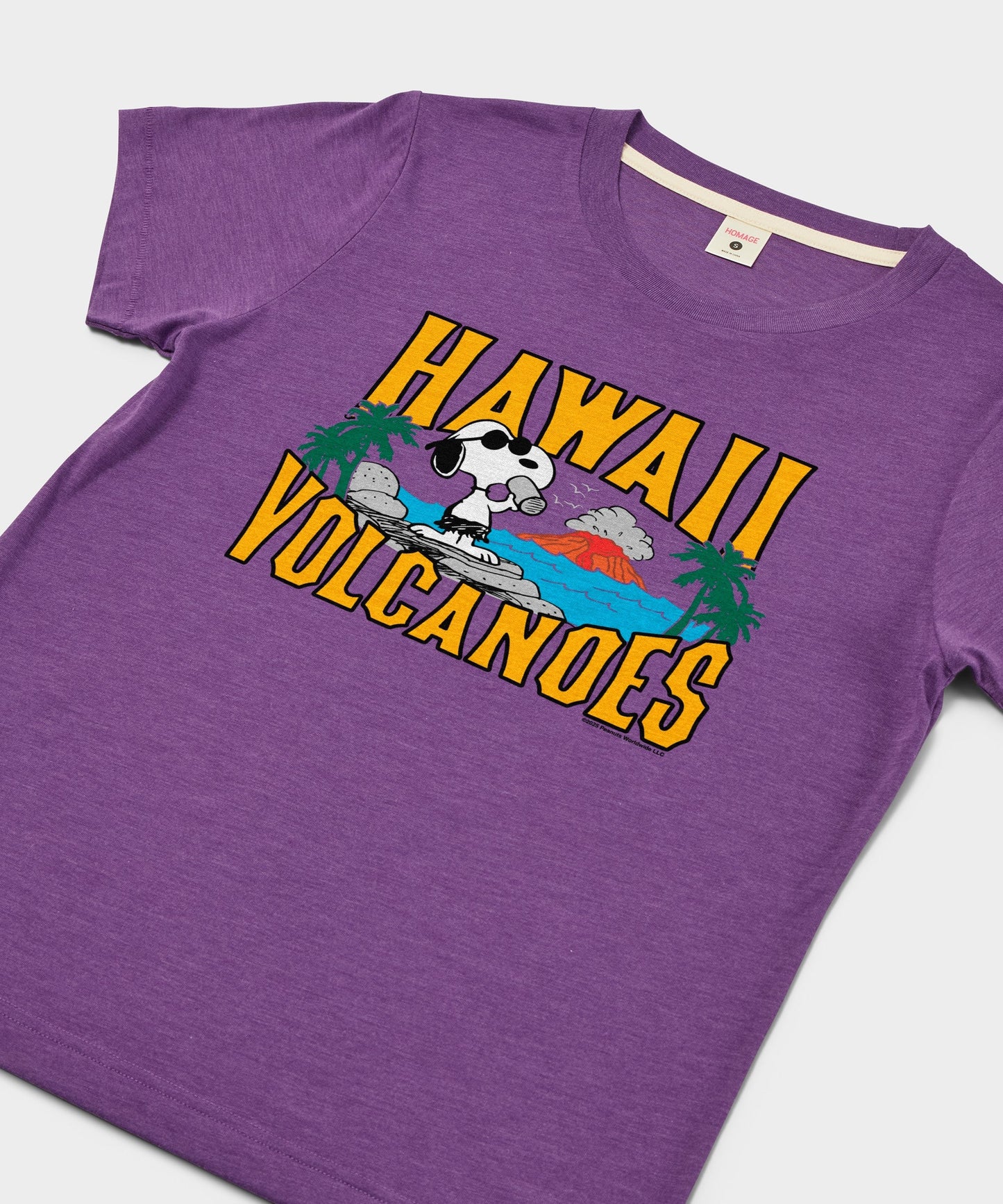 Close-up of the Snoopy Hawaii Volcanoes graphic illustration on the royal purple fabric