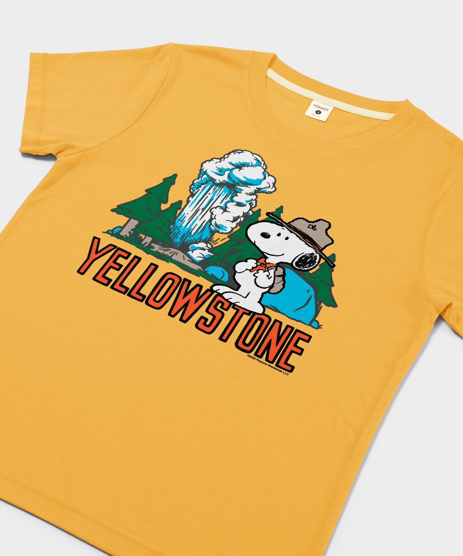 Close-up of the Snoopy and Yellowstone graphic printed on the chest of the gold t-shirt