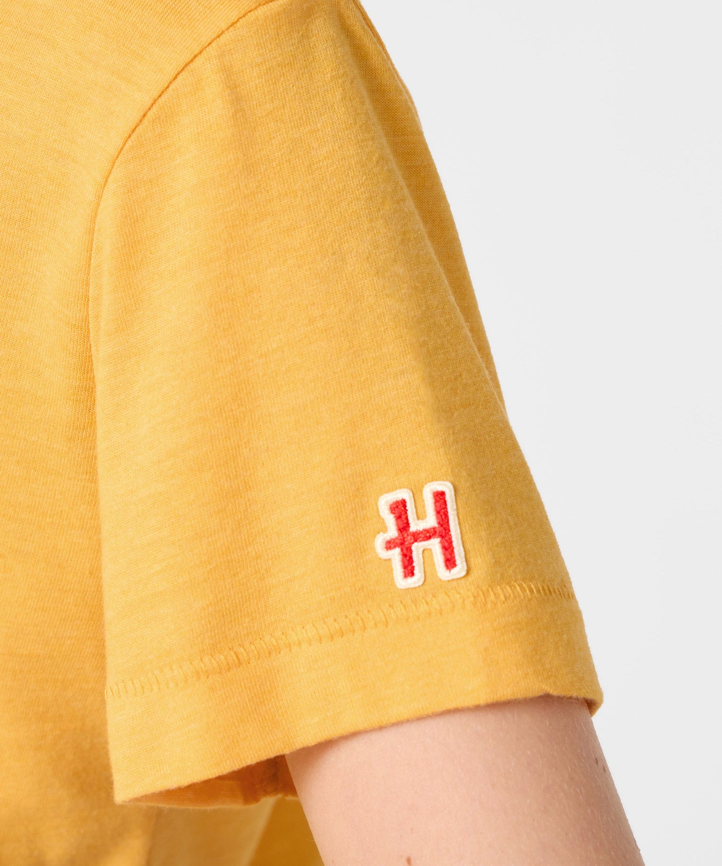 Folded view of the Peanuts youth t-shirt displaying the collaboration tag