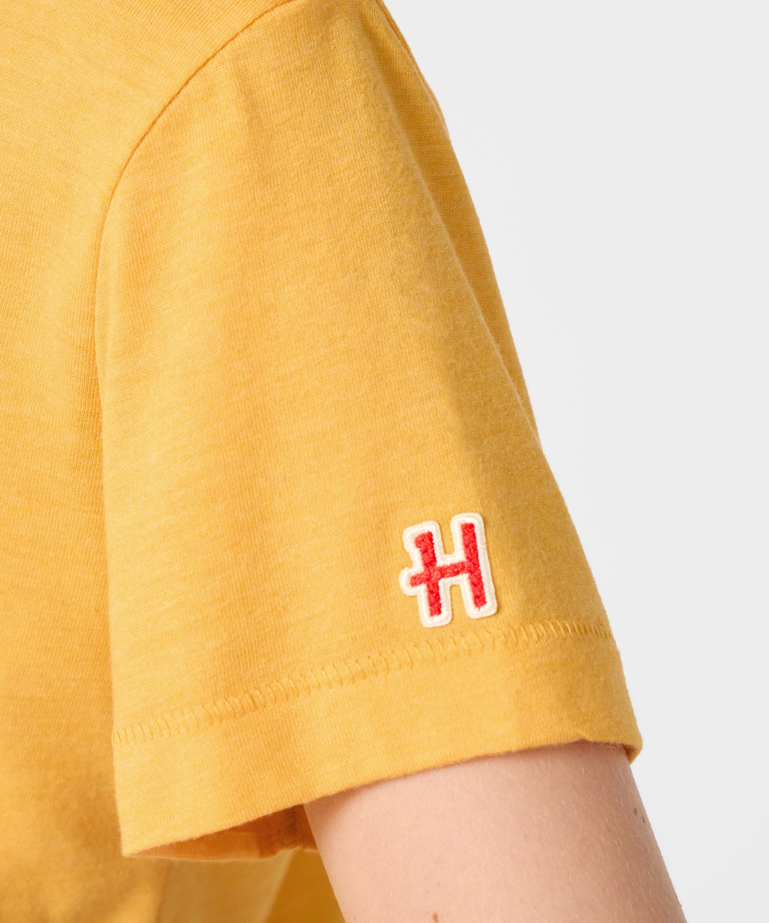 Folded view of the Peanuts youth t-shirt displaying the collaboration tag