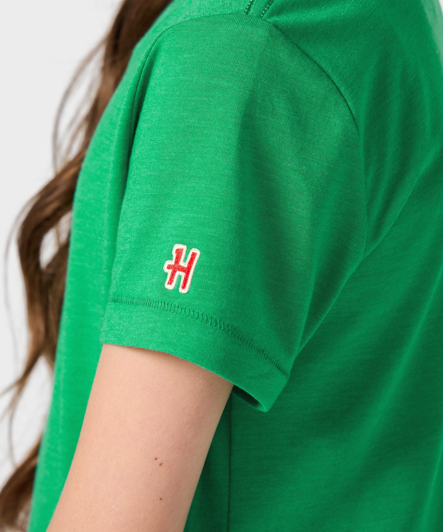 Folded view of the buttery soft green Peanuts youth graphic tee
