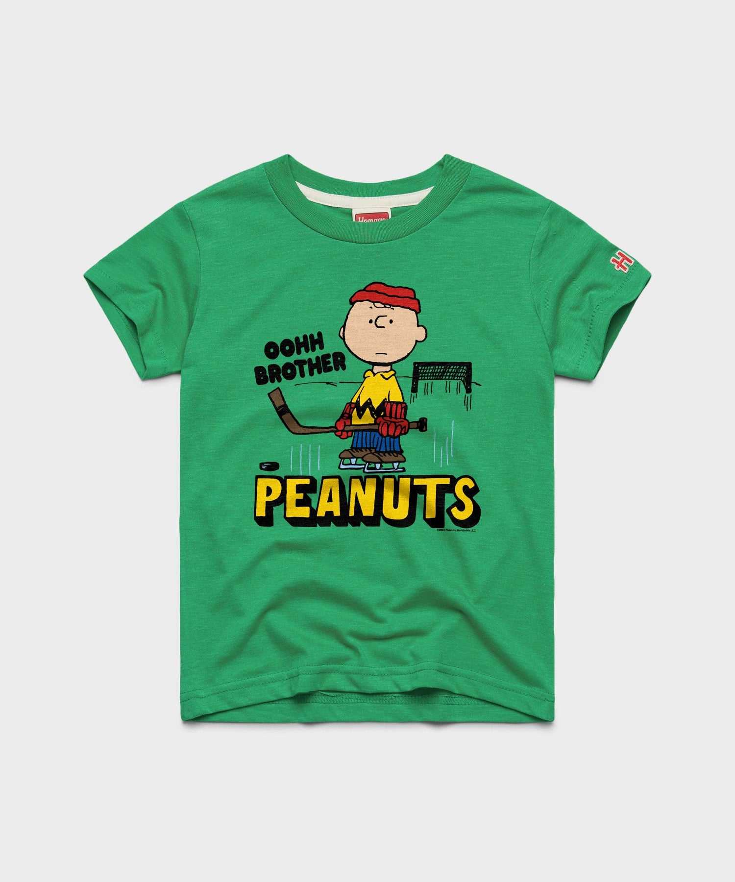 Green youth t-shirt featuring Charlie Brown ready to block a shot on the front