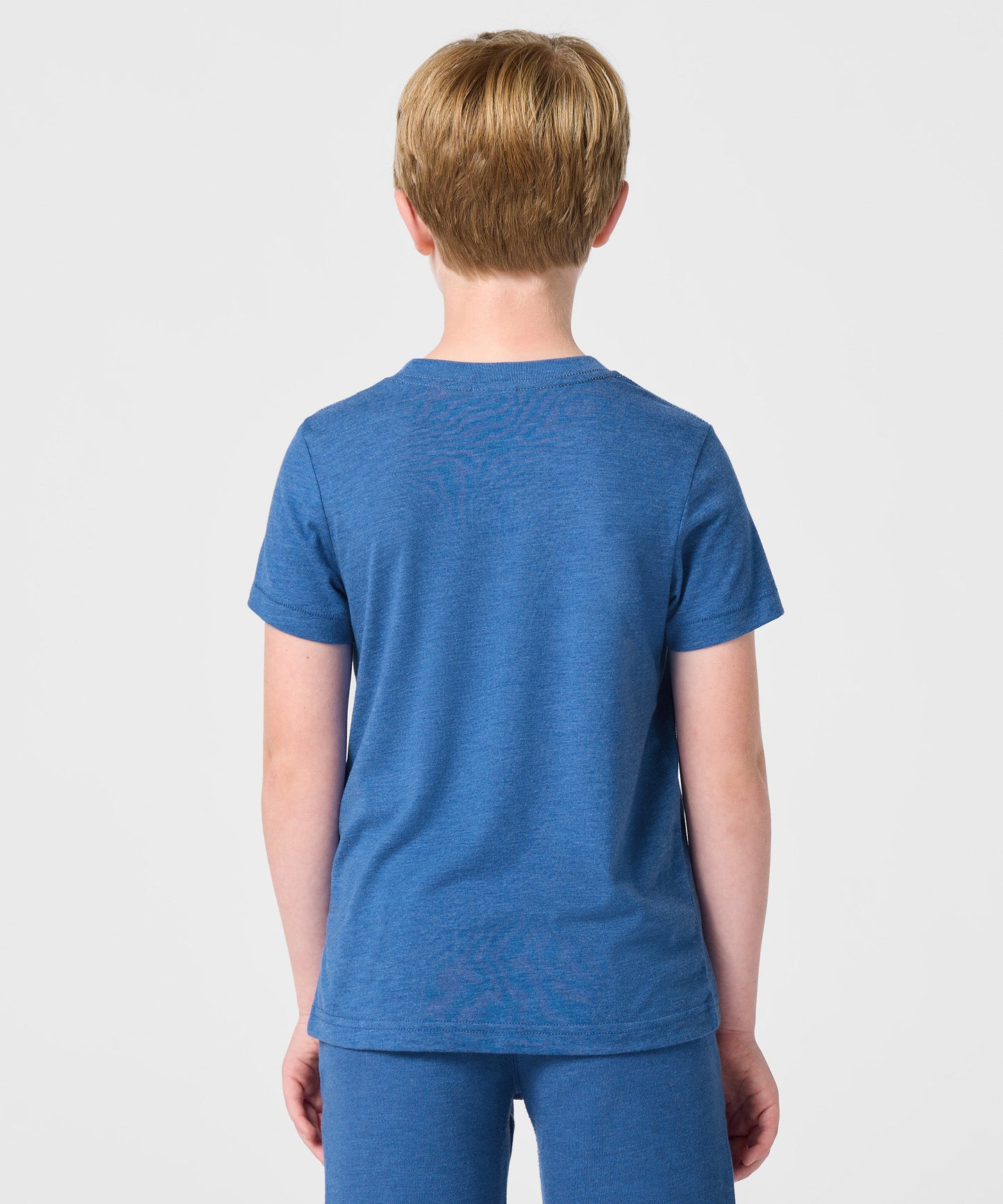 Detailed view of the HOMAGE collar tag and soft cotton fabric texture inside the youth t-shirt