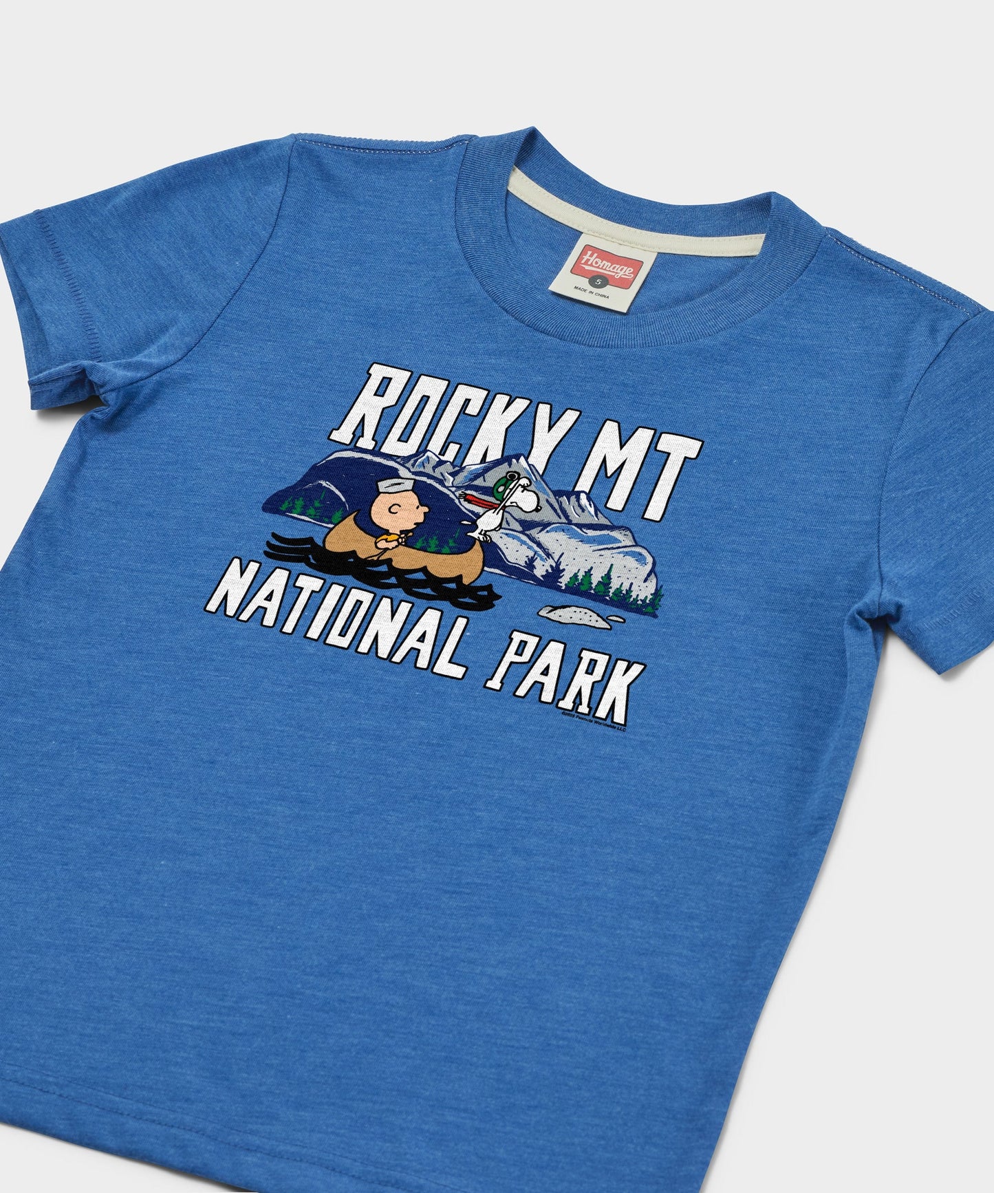 Close-up of the Charlie Brown and Rocky Mountain National Park screen-printed graphic on the front of the royal blue tee