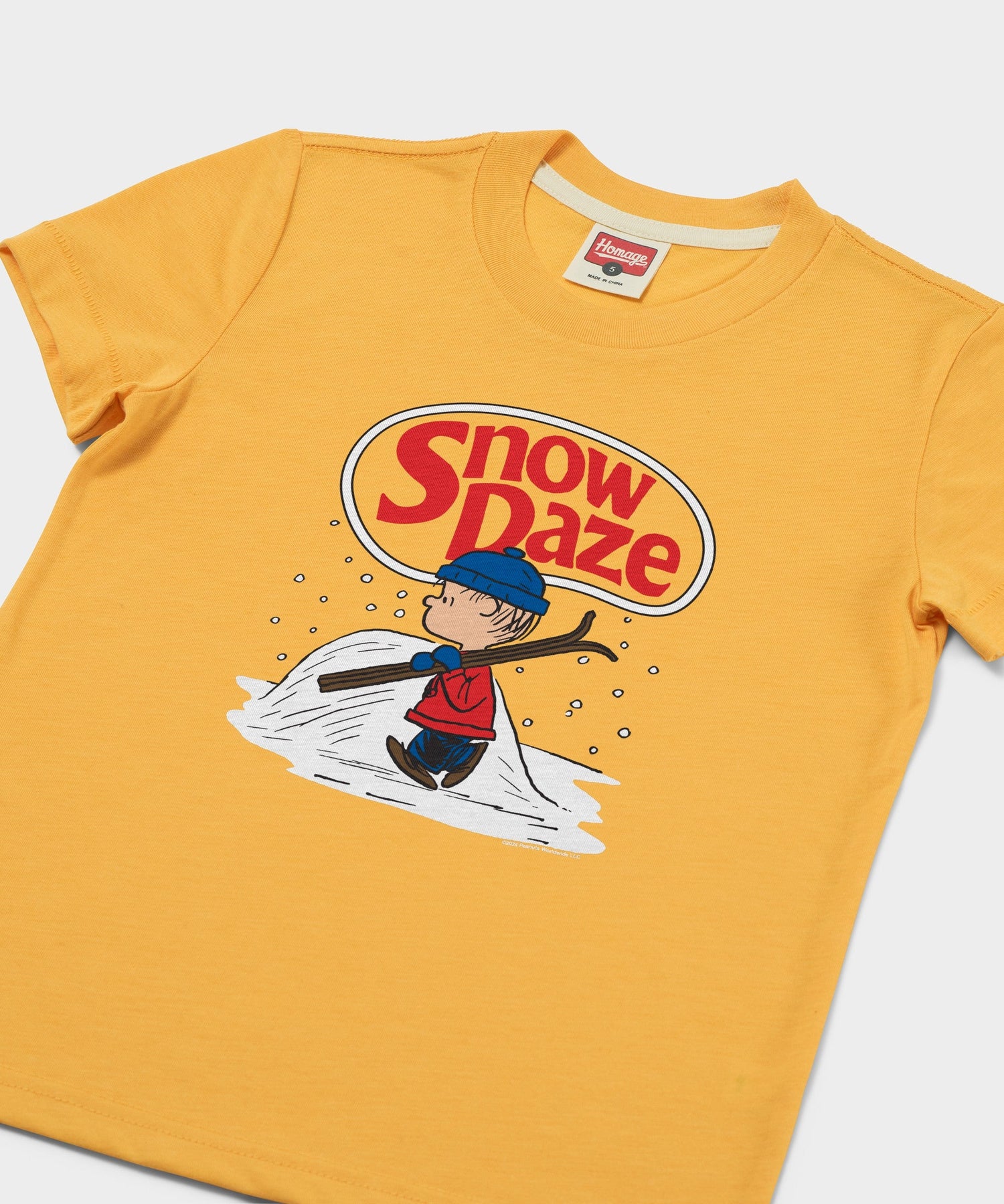 Close-up of the Linus graphic print on the front of the gold youth sweatshirt