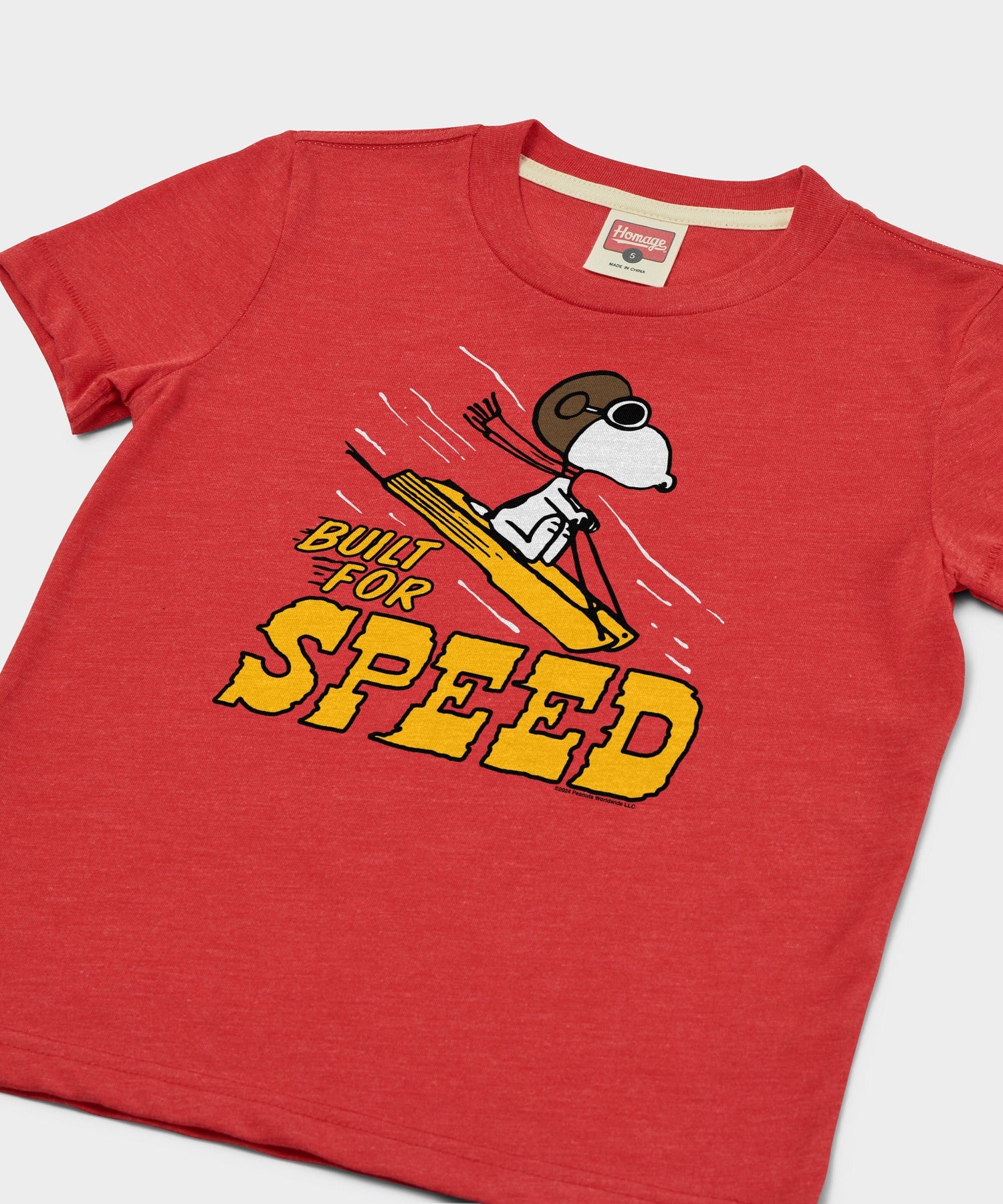 Close-up of the front chest graphic featuring Snoopy racing down a snowy hill